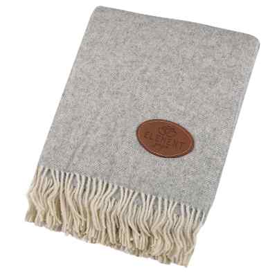 Wool herringbone fringe blanket with custom debossed logo.