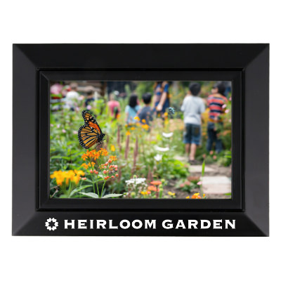 Black wooden picture frame with a branded imprint.