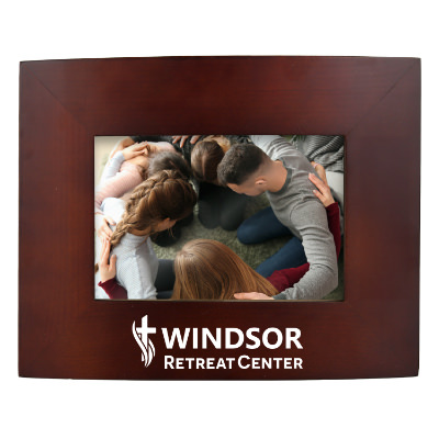 Walnut wooden picture frame with a personalized imprint.