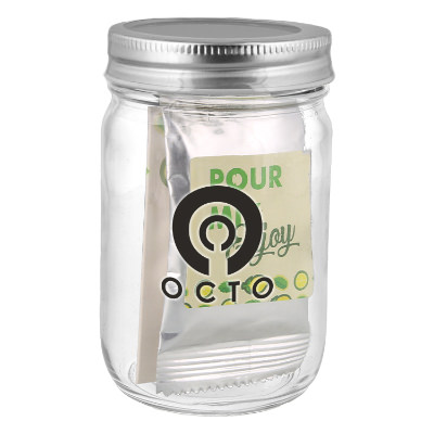 Clear glass majon jar with a branded logo.