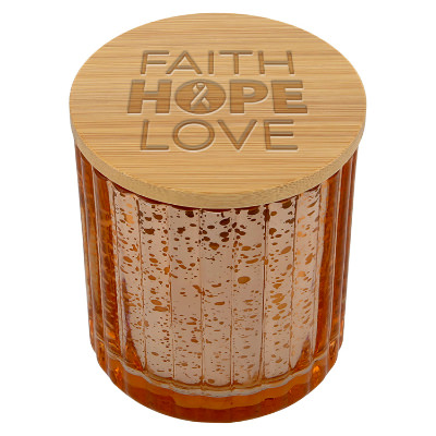 Copper glass candle with a branded logo.