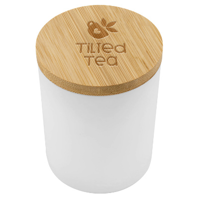 White glass candle with a branded logo.