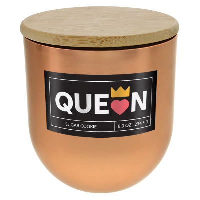 Copper glass candle with a branded logo.