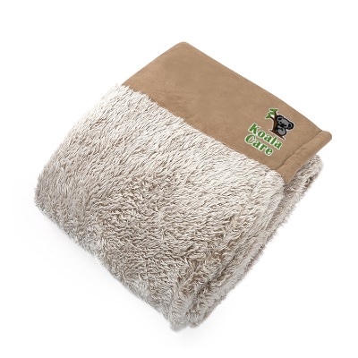 Super soft tan and cream plush blanket with embroidered design.