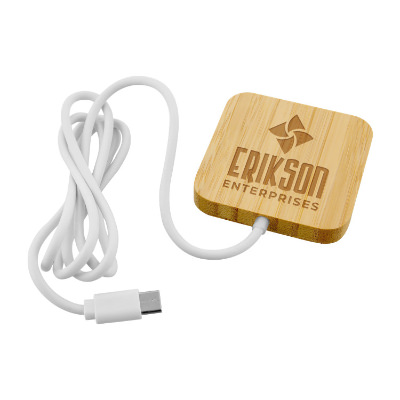Natural bamboo wireless charger with a branded imprint.