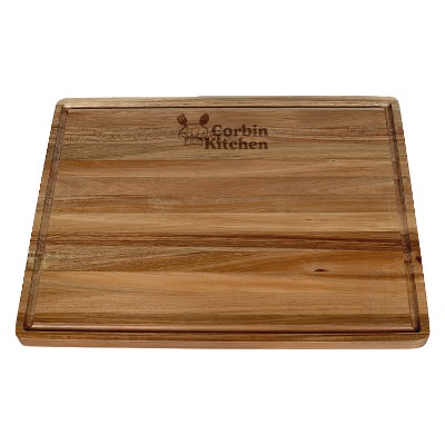 Acacia wood cutting board with personalized laser engraved imprint.