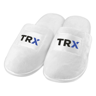 White fuzzy slippers with custom full-color logo.