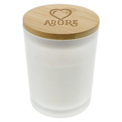 White glass candle with a branded logo.