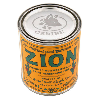 Silver metal candle with a branded imprint.
