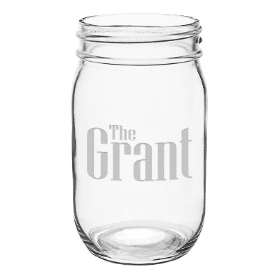 Clear mason jar with engraved logo.