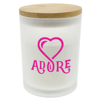 White glass candle with a branded logo.