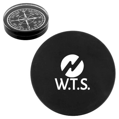 Black and white compass paperweight with promotional logo.