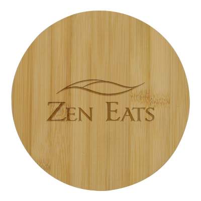Natural round bamboo cutting board with custom laser engraved imprint.