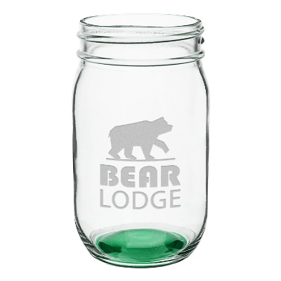 Green mason jar with engraved logo.
