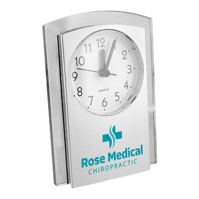Silver metal clock with a branded logo.