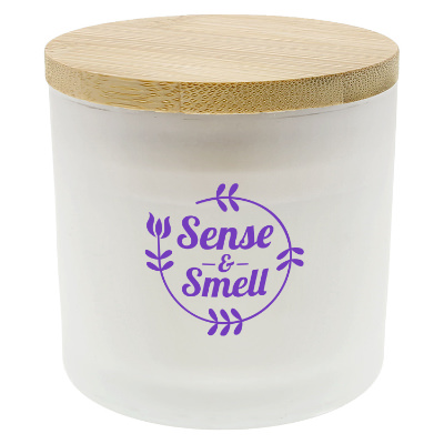 White glass candle with a branded logo.