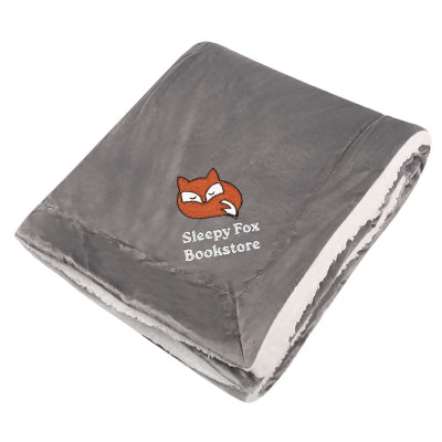 Solid gray sherpa throw blanket with embroidered design.